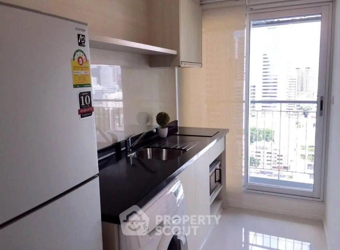 Modern kitchen with sleek appliances and city view from large window