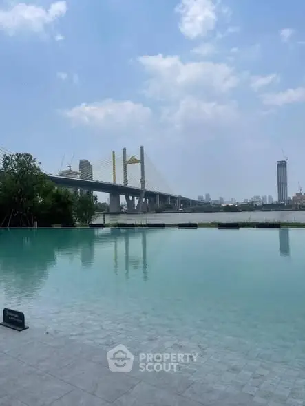 Stunning poolside view with iconic bridge and city skyline, perfect for luxury urban living.