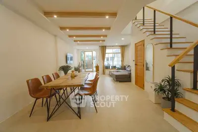 Spacious modern living room with dining area and stylish staircase
