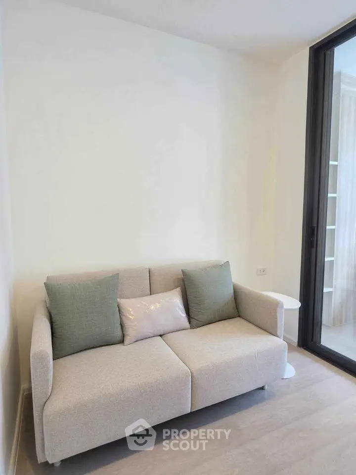 Cozy living room with modern sofa and large window for natural light