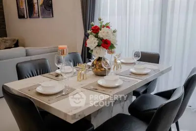 Elegant dining area with marble table and stylish decor in modern living room