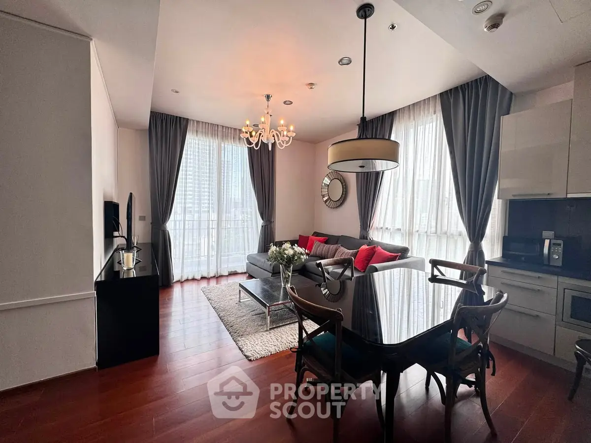 Elegant living room with modern decor, large windows, and stylish furniture in a luxurious apartment.