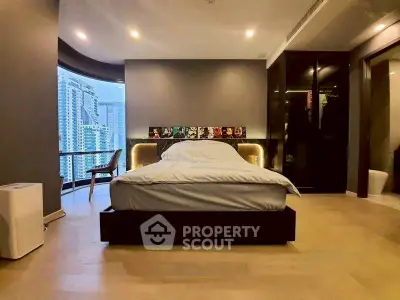 Luxurious bedroom with city view and modern decor, featuring a stylish bed and large windows.