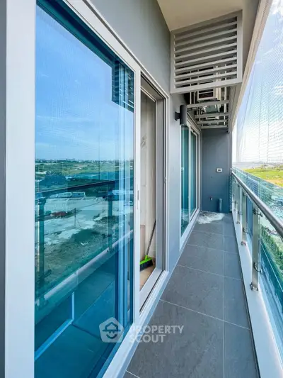 Modern balcony with glass railing and scenic view in contemporary apartment