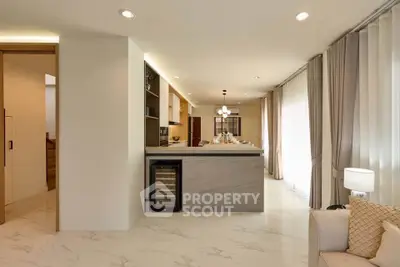 Luxurious open-plan living room with modern kitchen and elegant marble flooring.