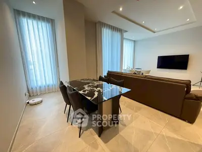 Modern living room with elegant marble dining table and sleek leather sofa, featuring floor-to-ceiling windows.