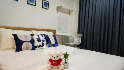 Cozy bedroom with modern decor and plush teddy bear on bed, perfect for relaxation.