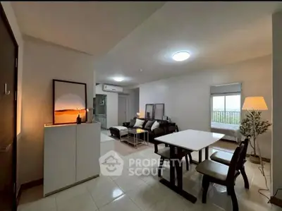Spacious modern living room with dining area and cozy lighting in a stylish apartment.