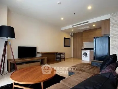 Modern living room with stylish furniture and integrated kitchen appliances