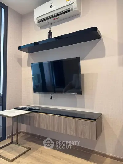 Modern living room with wall-mounted TV and sleek air conditioning unit.