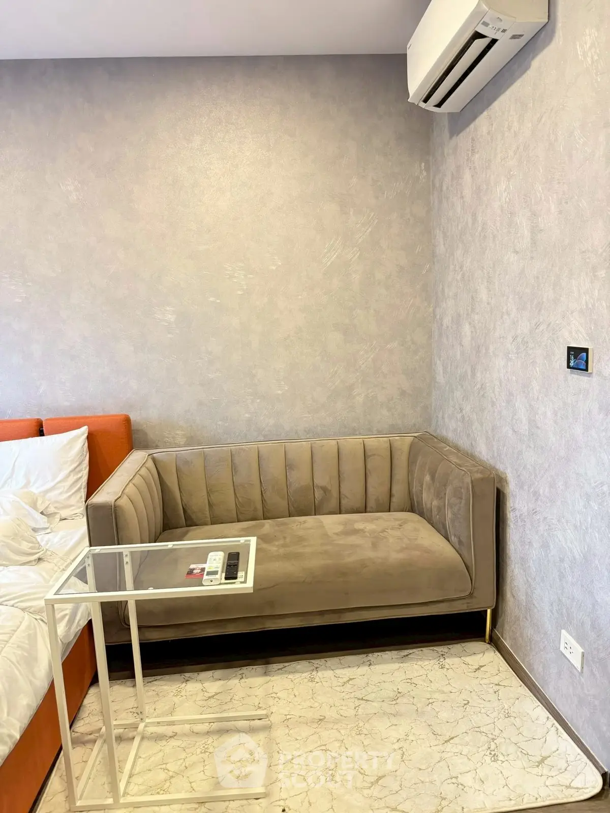 Modern living room with stylish sofa and air conditioning, perfect for comfort and relaxation.
