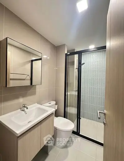 Modern bathroom with sleek fixtures and glass shower enclosure