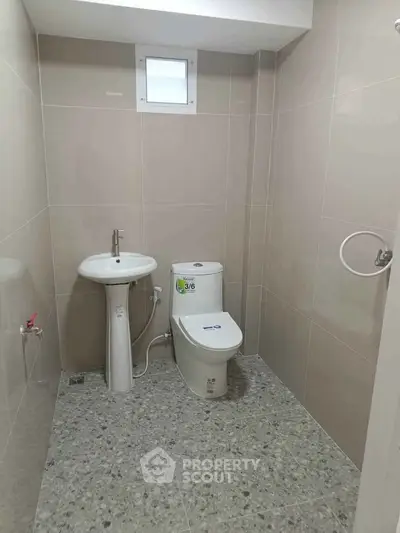 Modern bathroom with sleek fixtures and neutral tiles, perfect for a minimalist design.