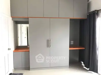 Modern bedroom with sleek built-in wardrobe and stylish curtains