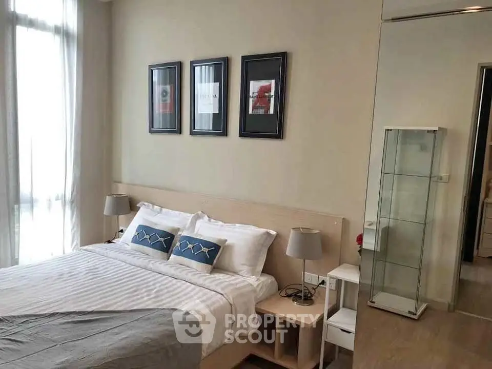 Modern bedroom with stylish decor and natural light, perfect for relaxation and comfort.
