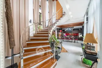 Luxurious modern living room with elegant staircase and open kitchen layout