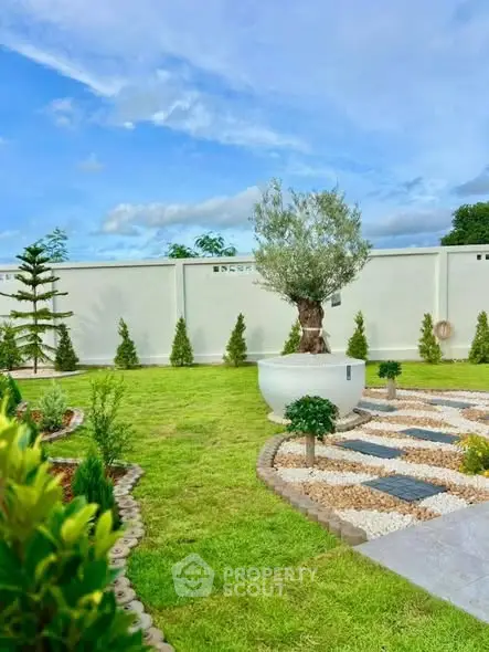 Beautifully landscaped garden with lush greenery and decorative pathways.