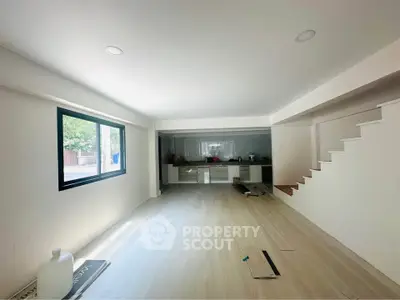 Spacious modern living room with open layout and large window for natural light