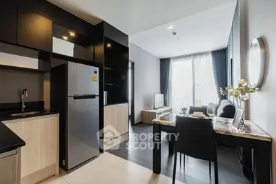 Modern open-layout kitchen and living room with sleek design and natural light.