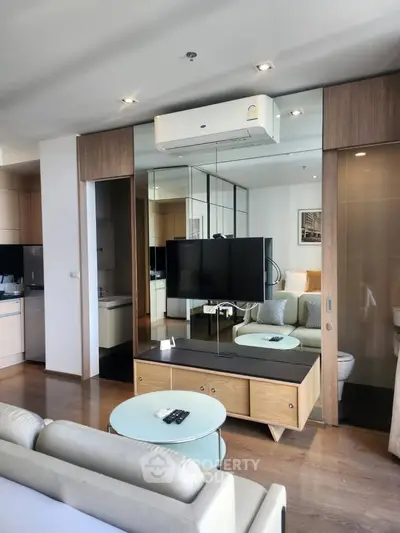 Modern living room with sleek design and integrated kitchen area