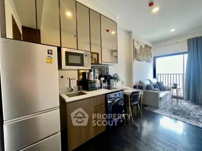 Modern open-layout kitchen and living room with sleek appliances and stylish decor