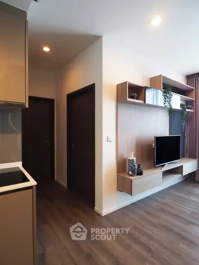 Modern living room with sleek wooden flooring and stylish TV unit