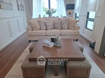 Elegant living room with stylish beige sofa and wooden coffee table, perfect for modern homes.