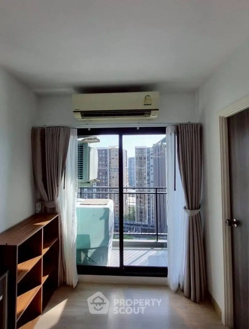 Bright room with balcony and city view, featuring air conditioning and modern decor.