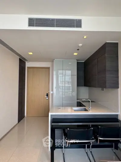 Modern kitchen with sleek cabinetry and breakfast bar in a stylish apartment
