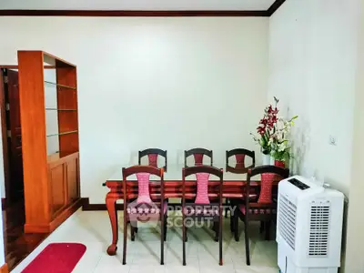 Elegant dining area with wooden table and chairs, featuring a stylish cabinet and air purifier.