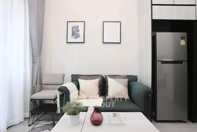 Modern living room with stylish decor and sleek refrigerator, perfect for urban living.