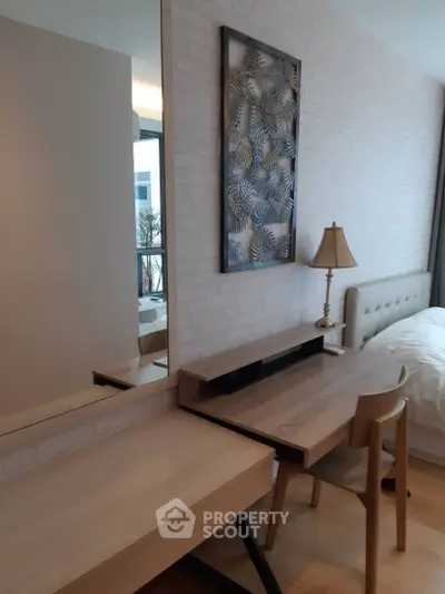 Modern bedroom with stylish decor and natural light, featuring a cozy bed and elegant furniture.