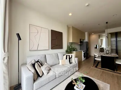 Modern living room with stylish decor and open kitchen layout in a contemporary apartment.
