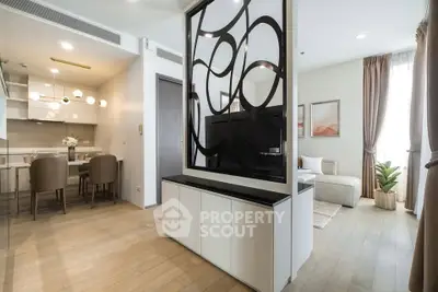 Modern open-plan living room with stylish partition and dining area in a contemporary apartment.