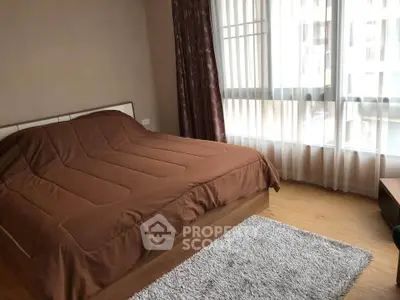 Cozy bedroom with large window and stylish decor in modern apartment