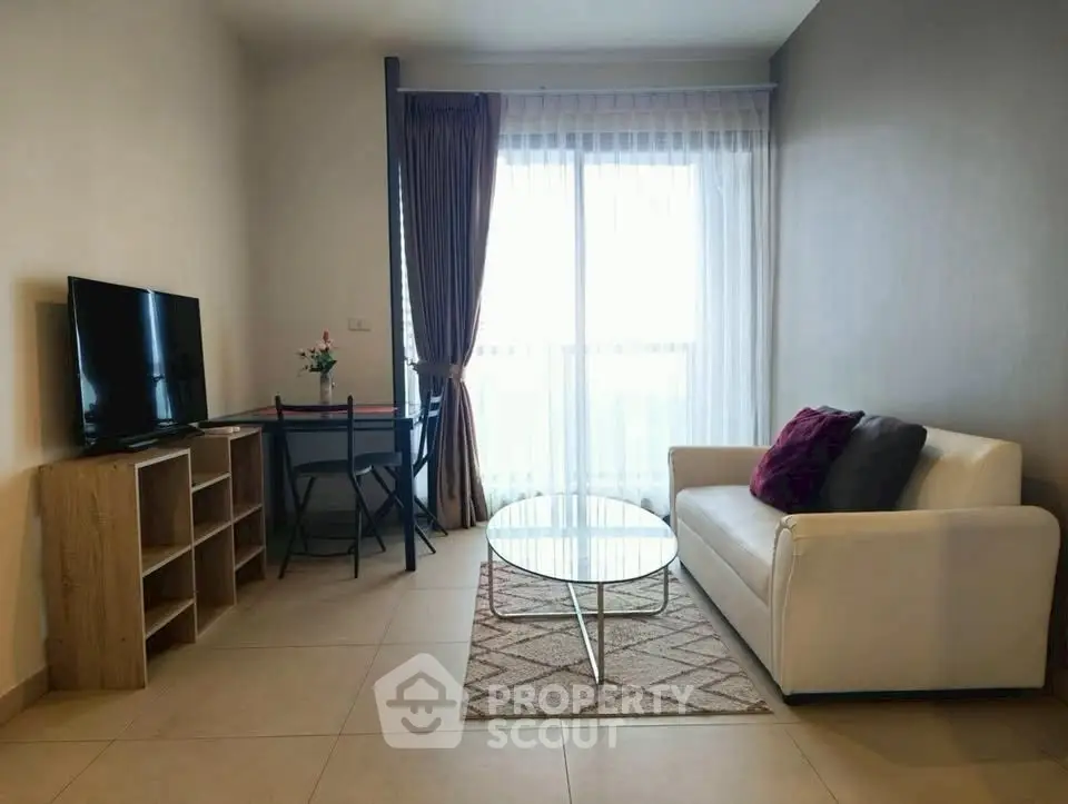 Modern living room with cozy sofa and TV, perfect for relaxation.