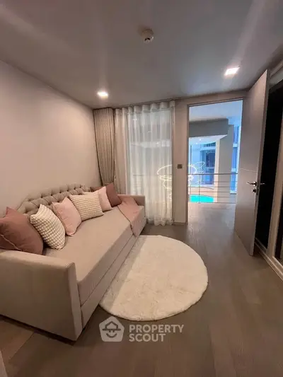 Cozy living room with elegant sofa and soft lighting, perfect for relaxation.