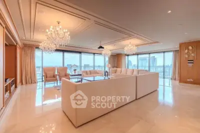 Luxurious living room with chandeliers and panoramic city view, featuring elegant seating and expansive windows.