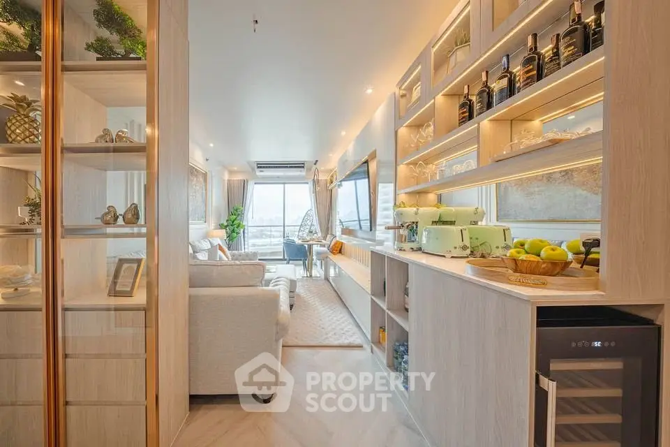 Luxurious modern living room with open kitchen and stunning city view, featuring elegant decor and ample natural light.