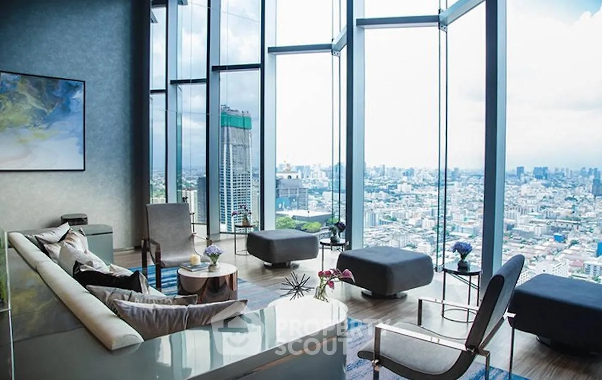 Luxurious living room with panoramic city view and modern furnishings.