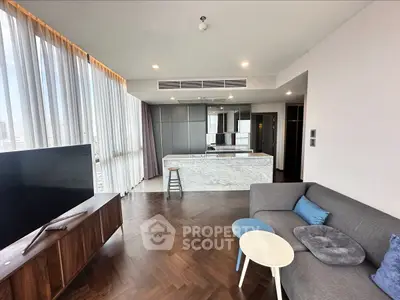 Modern living room with open kitchen and stylish furniture in high-rise apartment