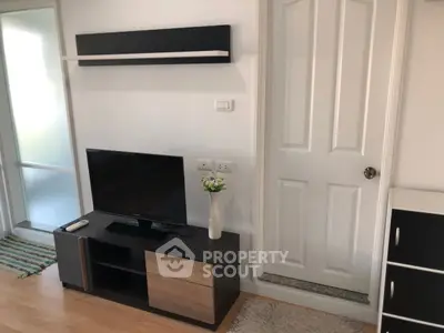 Modern living room with sleek TV stand and decorative shelf, perfect for cozy entertainment.