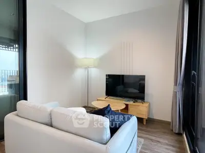 Cozy living room with modern decor and large windows for natural light.