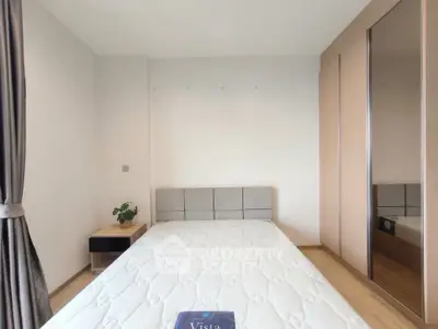 Modern bedroom with minimalist decor and large wardrobe