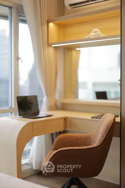 Modern study area with sleek desk and comfortable chair by a large window