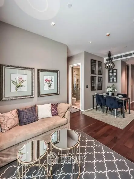 Stylish living room with elegant decor and dining area in modern apartment.