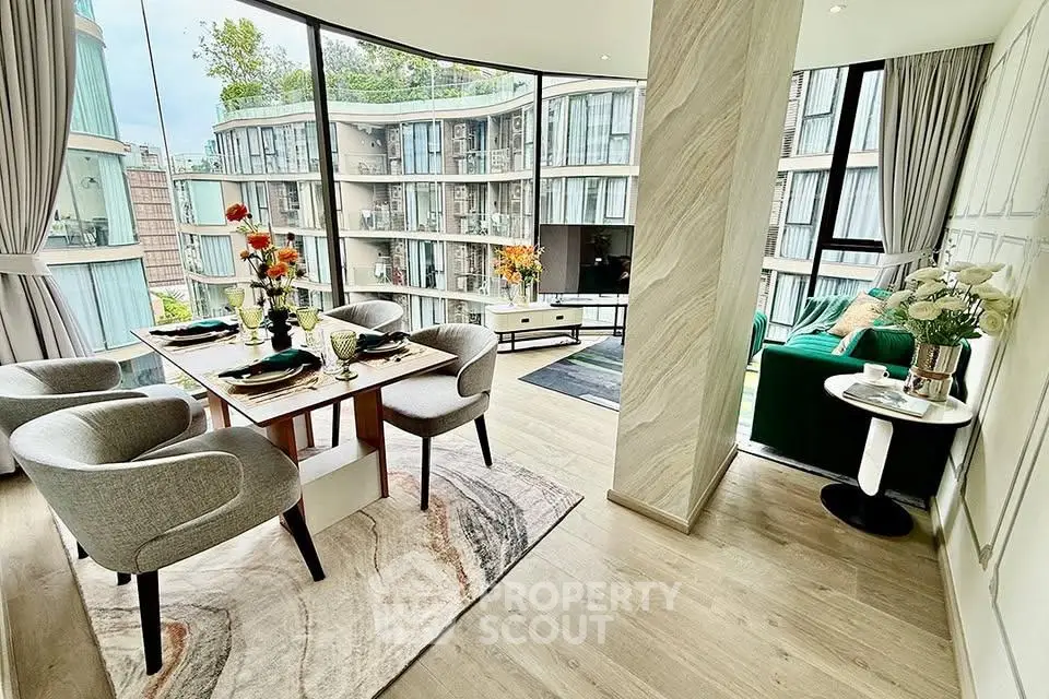 Luxurious open-plan living and dining area with floor-to-ceiling windows and modern decor.