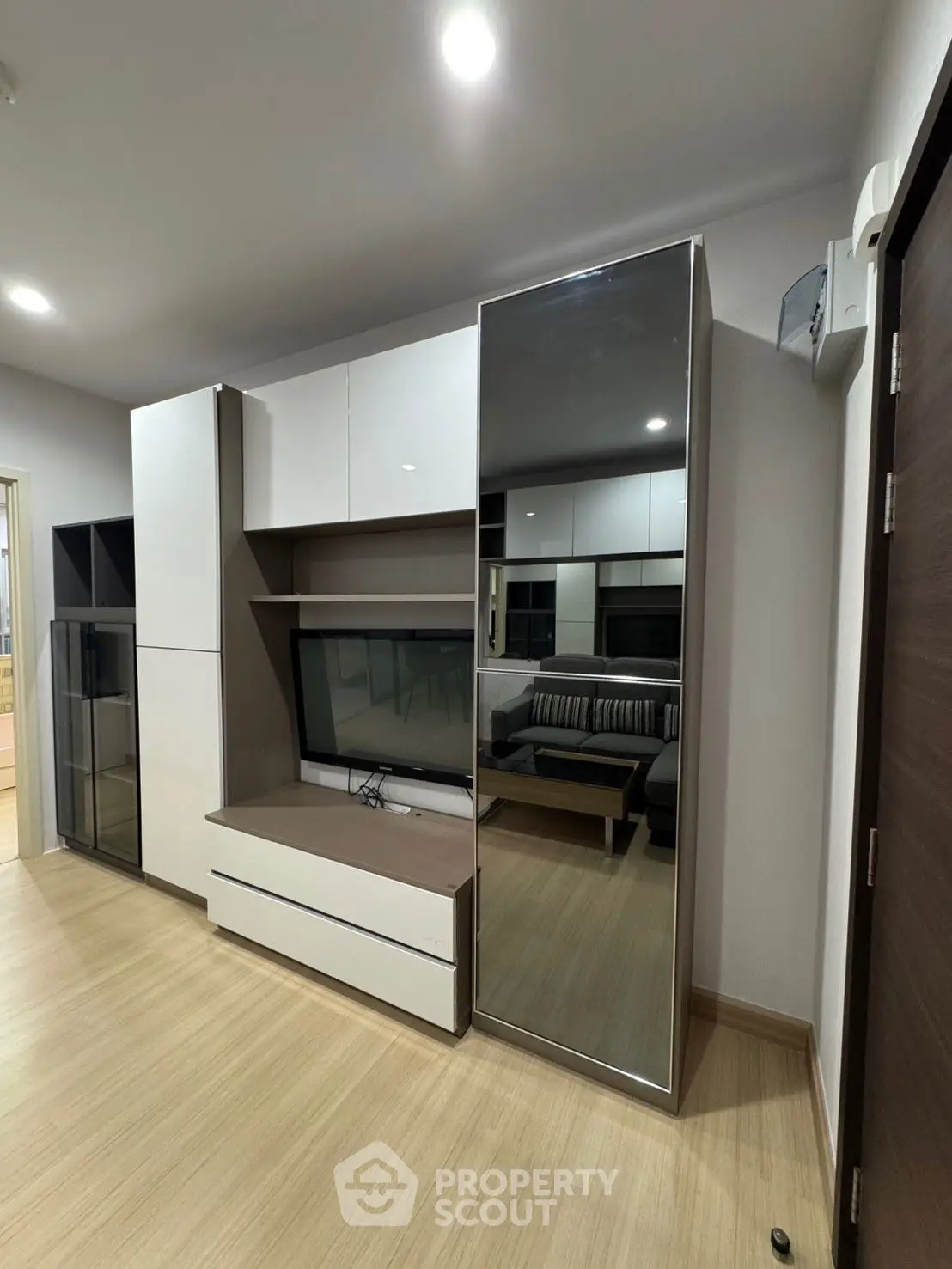 Modern living room with sleek entertainment unit and cozy seating area