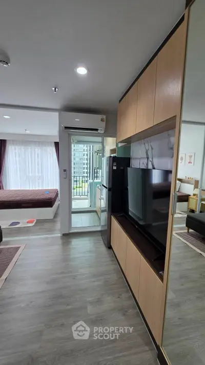 Modern studio apartment with open layout and balcony view