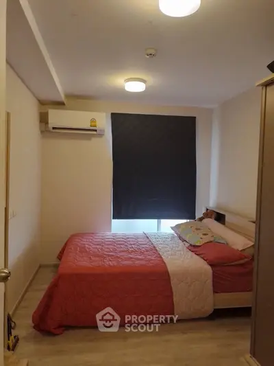 Cozy bedroom with modern decor and air conditioning, perfect for restful nights.